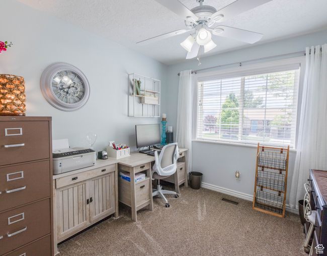 Office space with a ceiling fan, light carpet, and baseboards | Image 12