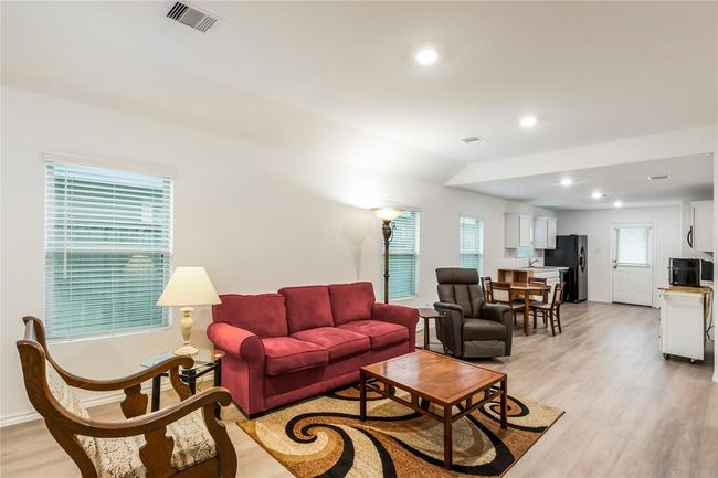 Step into the cozy living room, featuring natural light, soft flooring, and the perfect setup for family movie nights. | Image 4