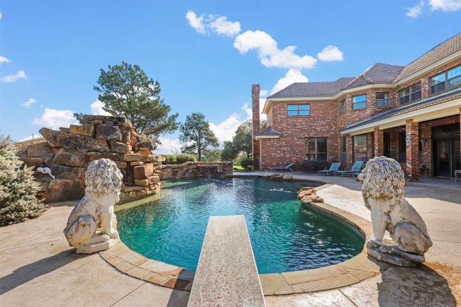 View of pool with a diving board, a patio, and pool water feature | Image 28