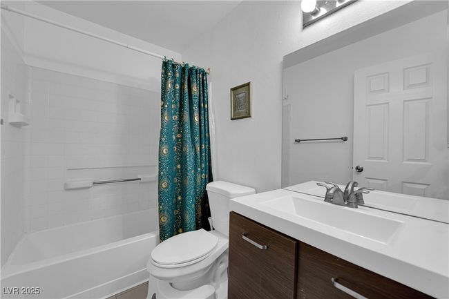 Full bath featuring vanity, toilet, and shower / bath combination with curtain | Image 12