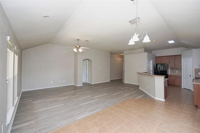 A view from the dining area open to the family room. Wonderful high ceilings and family room provides plenty of space for large sectional sofa and large entertainment system. | Image 7