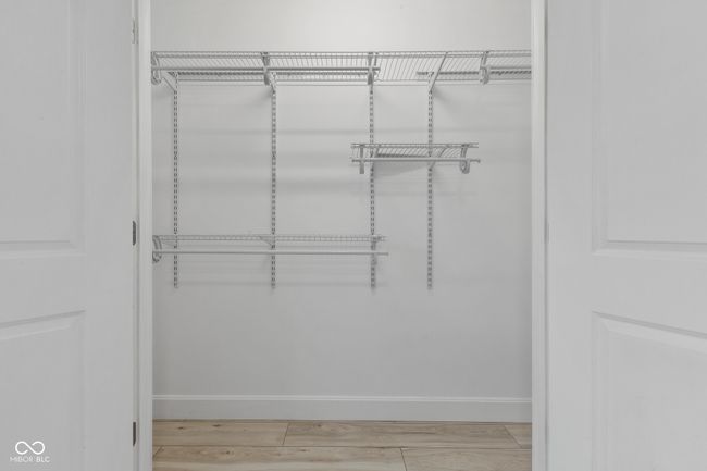 walk in closet featuring light wood-style flooring | Image 52