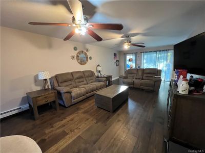 Living room with ceiling fan and dark hardwood / wood-style flooring | Image 1