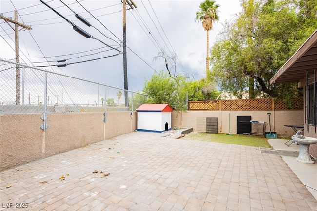 Fenced backyard with a storage shed and a patio | Image 20