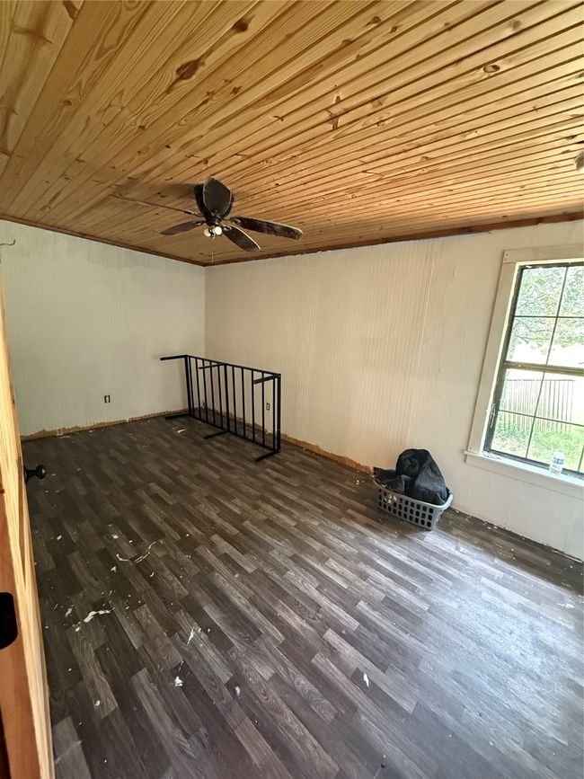 Unfurnished room featuring wood ceiling, dark wood-style flooring, and a ceiling fan | Image 32
