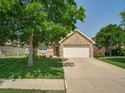 View of front of house with a garage and a front lawn | Image 1