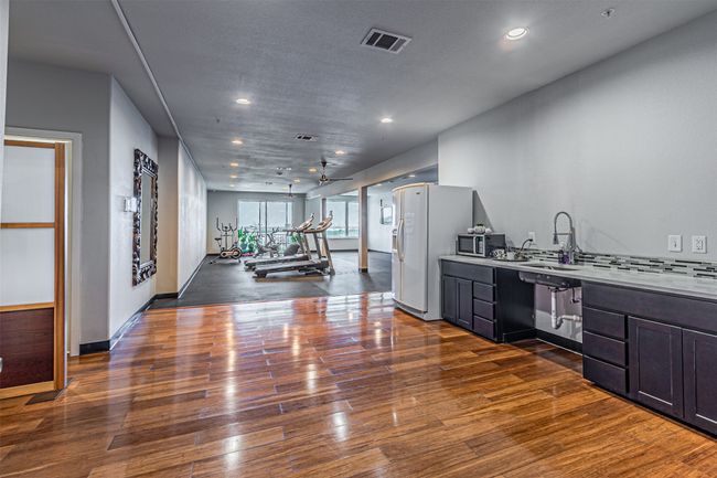 Kitchen featuring appliances with stainless steel finishes, wood finished floors, recessed lighting, light countertops, and ceiling fan | Image 22