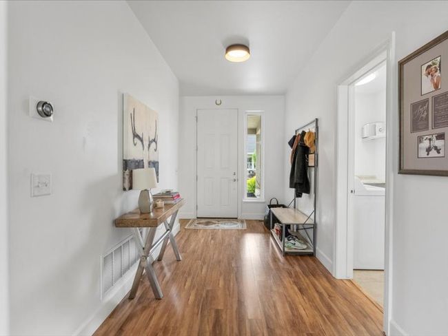 Foyer entrance featuring wood finished floors and washer / dryer | Image 17