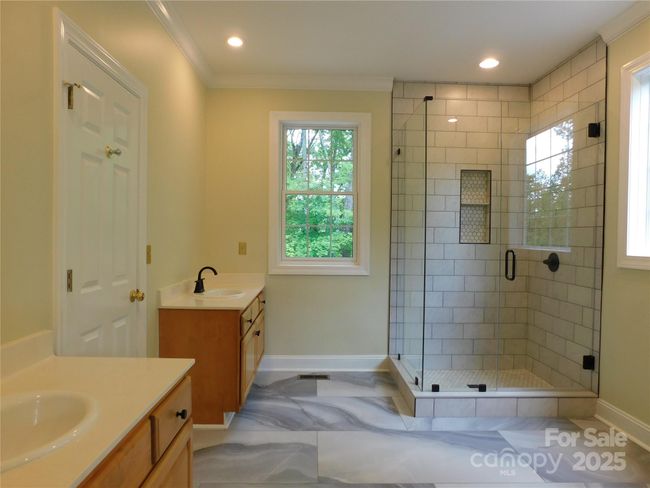 Primary bath with new tile floors and custom shower. Plumbing is available for the addition of a tub, if desired. | Image 27