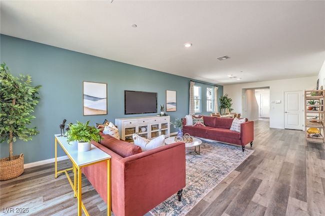 Living area featuring baseboards, wood finished floors, and recessed lighting. Photo is representational only; actual home finishes may vary. | Image 11