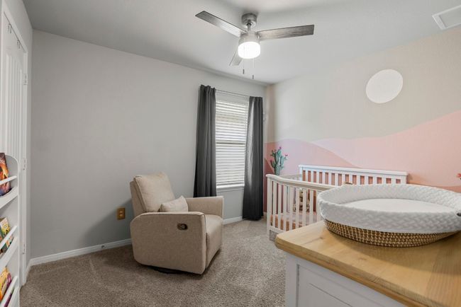 Bedroom featuring light carpet and a ceiling fan | Image 22