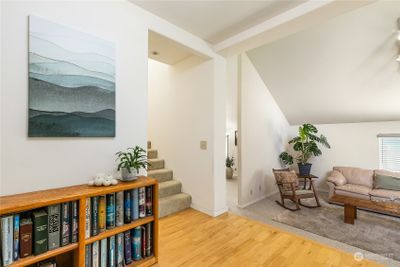 Entry with hardwood flooring and sunken living room to the right. | Image 3