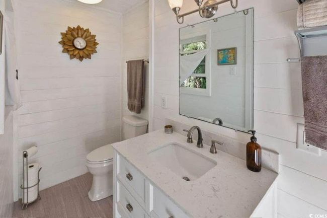 Bathroom with toilet, vanity, and wood finished floors | Image 18