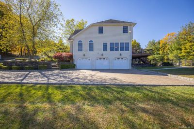 View of property exterior with a yard and a garage | Image 3