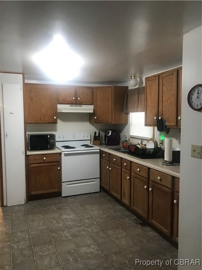Kitchen featuring stove and exhaust hood | Image 8