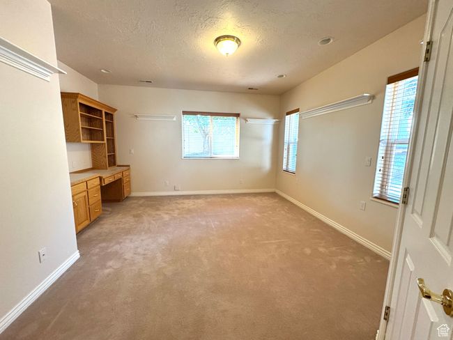 Bedroom featuring built-in cabinets, sink and walk-in closet. | Image 22