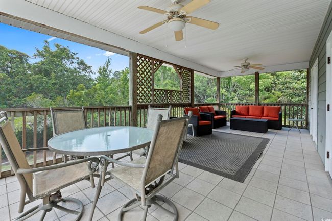 Sunroom featuring outdoor dining area, an outdoor hangout area, a ceiling fan, and healthy amount of natural light | Image 31