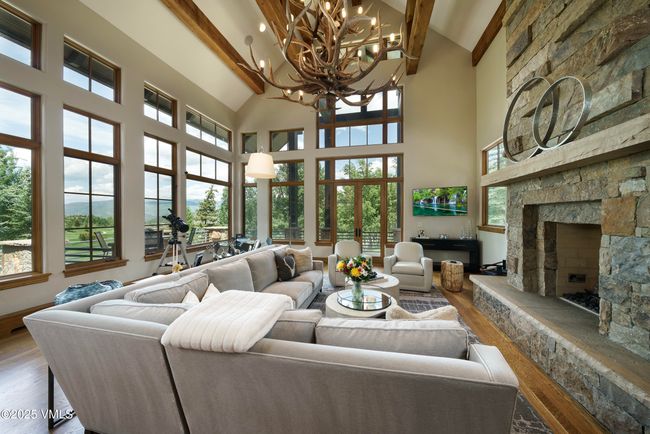 Vaulted Great Room With Panoramic Windows and a Striking Three-Sided Stone Fireplace. | Image 16