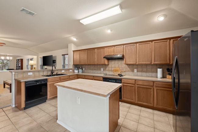 Another view of the kitchen looking into the breakfast area and living room. | Image 21