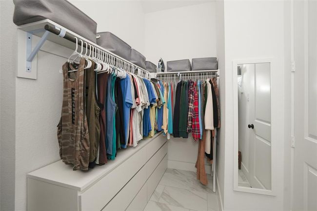 Spacious walk-in closet with ample storage. | Image 26