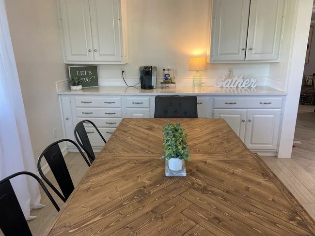 Kitchen with white cabinets and parquet floors | Image 11