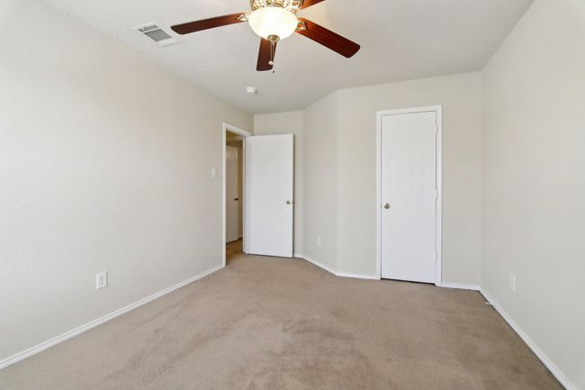 Unfurnished bedroom with carpet floors, baseboards, ceiling fan, and visible vents | Image 28