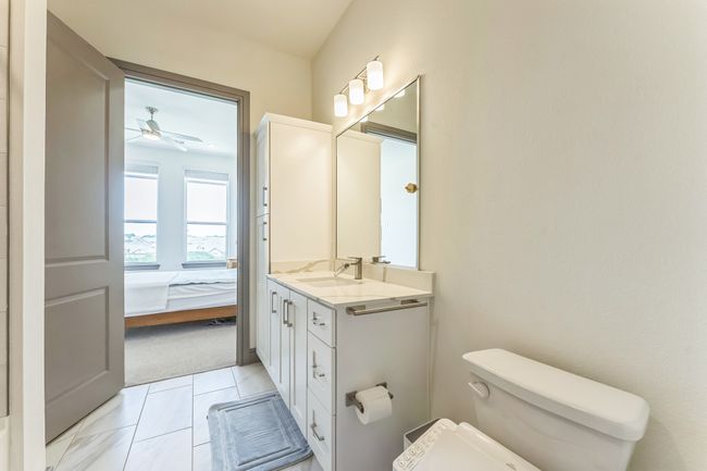 Bathroom with vanity, ceiling fan, ensuite bathroom, and tile patterned flooring | Image 17