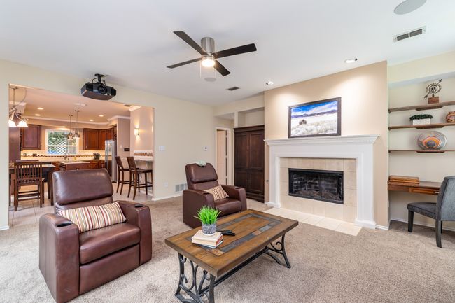 Detailed view of carpet, a desk, and a tiled fireplace | Image 13