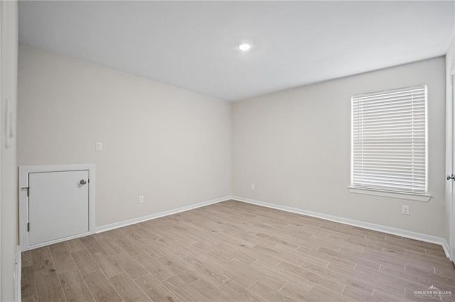Spare room featuring light wood-style floors and baseboards | Image 6