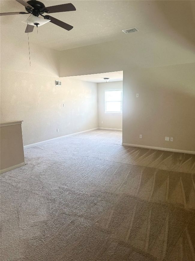 Empty room with carpet flooring and a ceiling fan | Image 9