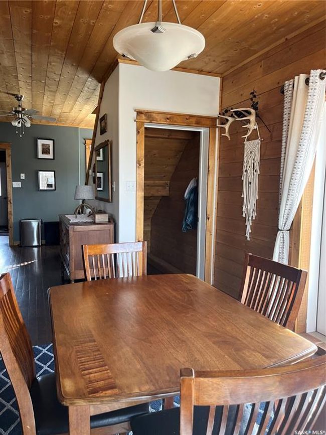 Dining area with wooden ceiling, hardwood / wood-style flooring, a ceiling fan, and wood walls | Image 17