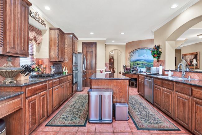 Preparing meals for family and friends will be a dream in this kitchen with a gas cooktop, built-in oven and microwave plus a walk-in pantry. | Image 9