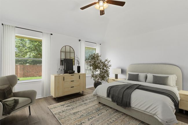 Bedroom featuring wood finished floors, a ceiling fan, and lofted ceiling | Image 15