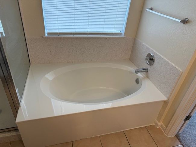 Bathroom featuring a bath, healthy amount of natural light, and tile patterned floors | Image 10