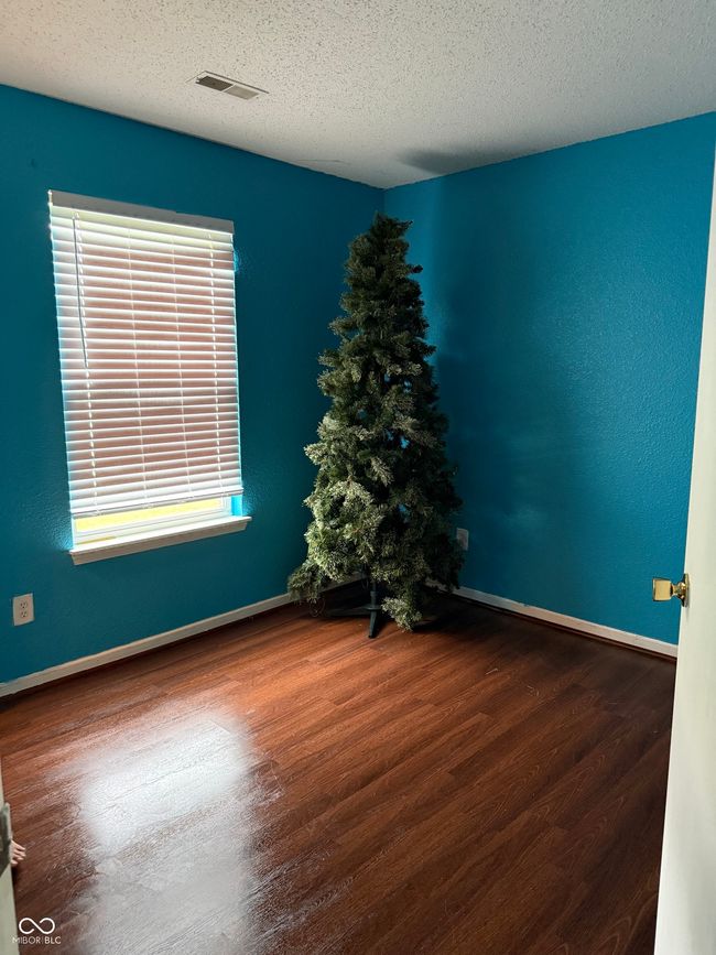 unfurnished room featuring wood finished floors and a textured ceiling | Image 11