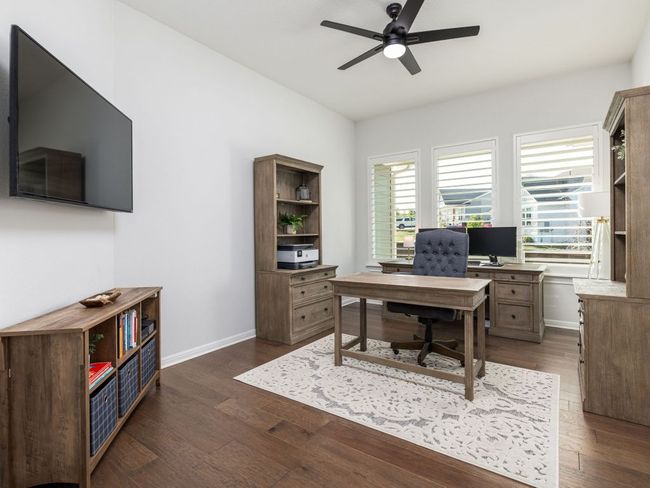 Office area featuring dark wood-style flooring, ceiling fan, and baseboards | Image 7