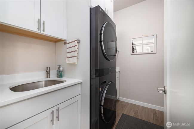 The utility was customized with matching cabinets, a utility sink and stackable steam washer/dryer that stays! | Image 12