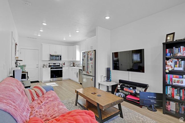 Living room featuring light wood-style flooring and recessed lighting | Image 5
