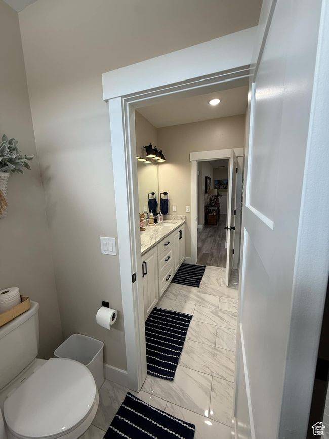 Bathroom with baseboards, marble finish floor, toilet, and vanity | Image 60