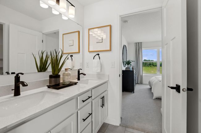 (Photo of a decorated model, actual homes finishes will vary) The Jack and Jill bath connects two of the secondary bedrooms. | Image 18