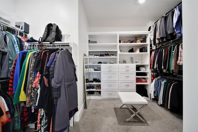 Oversized walk-in closet with built-in shelving for optimal organization. | Image 29