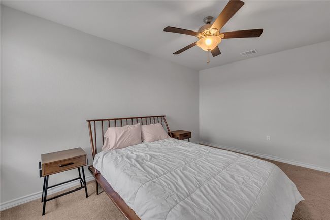Bedroom with carpet, baseboards, and a ceiling fan | Image 18
