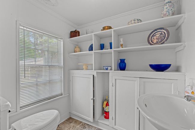 Bathroom featuring crown molding and a sink | Image 12