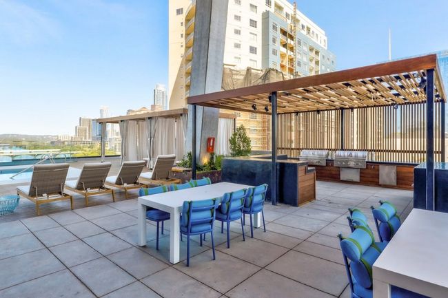 View of patio with outdoor dining area, an outdoor kitchen, and grilling area | Image 21