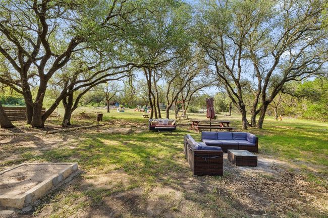 View of grassy yard with an outdoor living space | Image 33