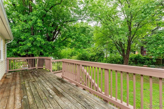 Wooden terrace with a yard and view of wooded area | Image 26