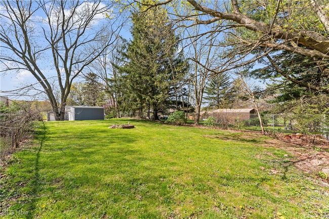 View of yard featuring an outbuilding and a fenced backyard | Image 7