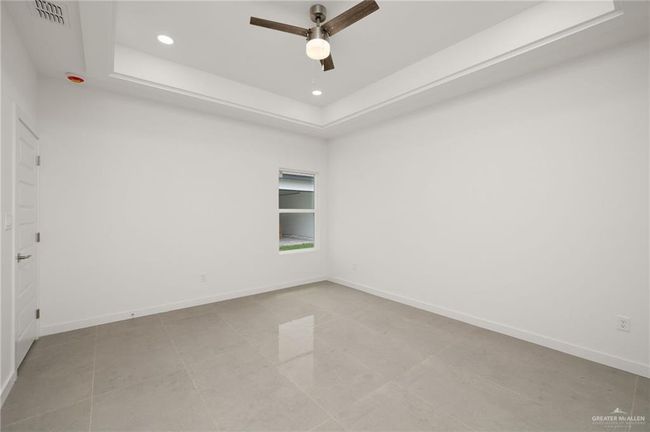 Spare room featuring recessed lighting, ceiling fan, and a tray ceiling | Image 8