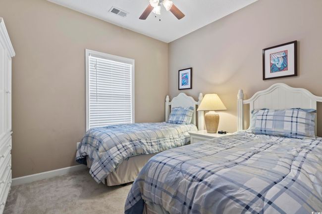Bedroom featuring light carpet, baseboards, and ceiling fan | Image 25