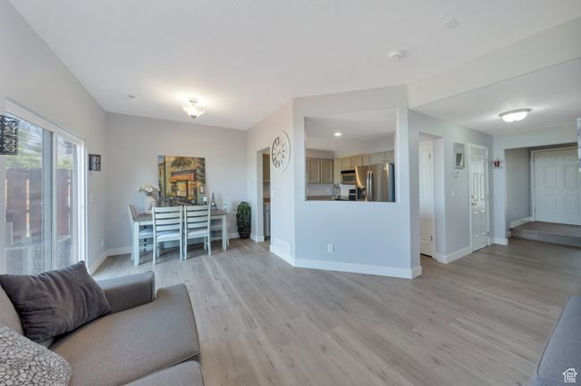 Living room with light wood laminate flooring | Image 4